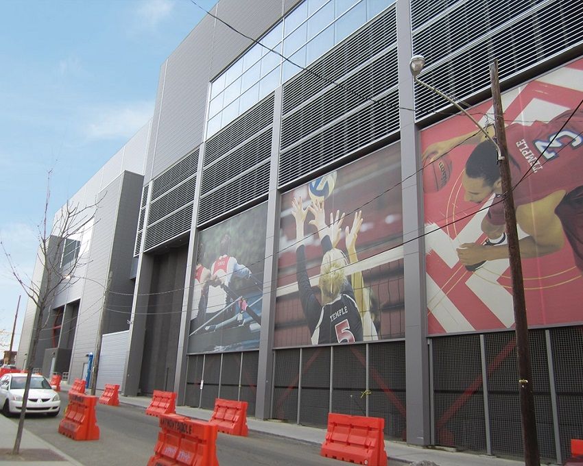 Ground level, view of sports team banners on side of Temple University building | facade restoration | O’Donnell & Naccarato